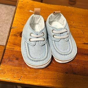 Lace up Carter’s 0 month shoes for infant.